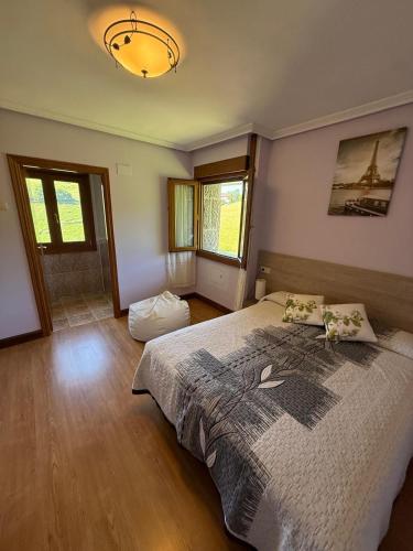 a bedroom with a large bed in a room at Izarra Urdaneta in Aizarna