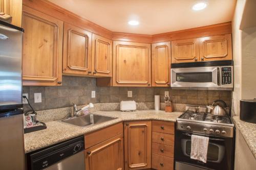 a kitchen with wooden cabinets and a stainless steel appliances at Villa 1041 - 3 Bed 3 Bath Full Kitchen villa in Midway