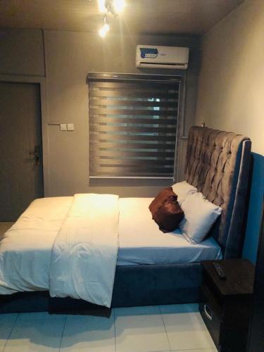 a bedroom with a bed with a pillow on it at Sandvica Luxe Homes in Port Harcourt
