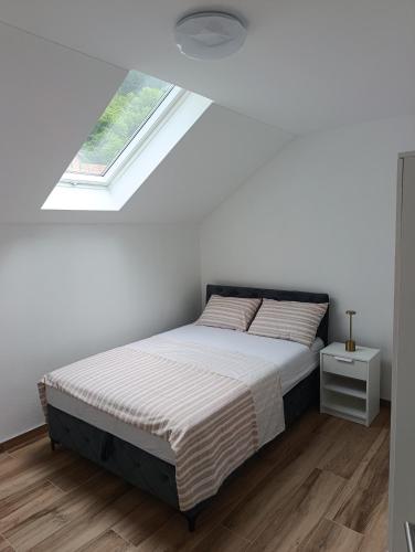 a bedroom with a bed and a window at Zen Zone Trio in Foča