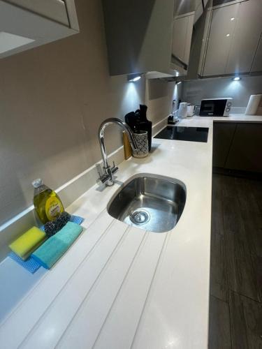 a kitchen counter with a sink in a kitchen at Stunning Sea View 2BR Flat Sleeps 5 Walk to Beach - Big Savings for Extended Stays - by Nestora Stays Ltd in Brighton & Hove
