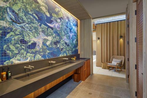 a bathroom with a large mural on the wall at Mauna Kea Beach Hotel, Autograph Collection in Hapuna Beach