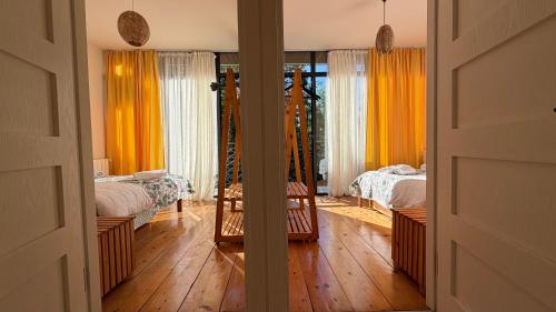 a room with two beds and a mirror at Chalet Kvariati in Kvariat'i