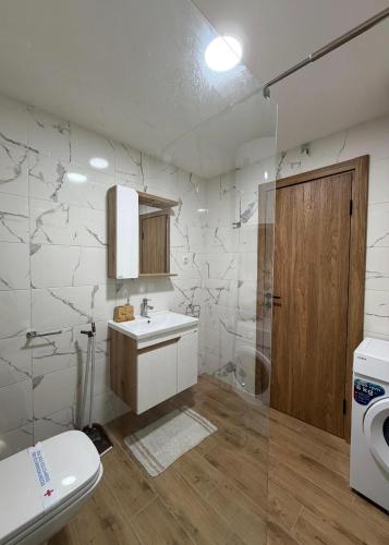 a bathroom with a sink and a toilet and a shower at Nota in Veliko Gradište