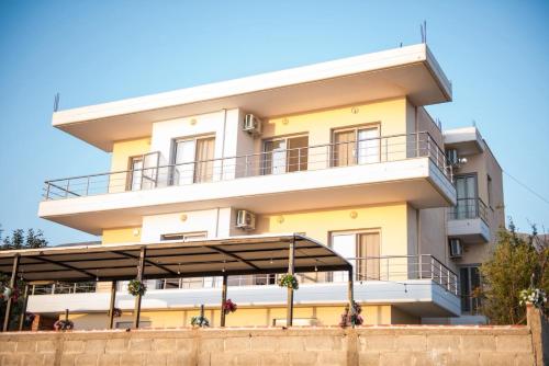 a building with a balcony in front of it at Seaview Radhime in Vlorë