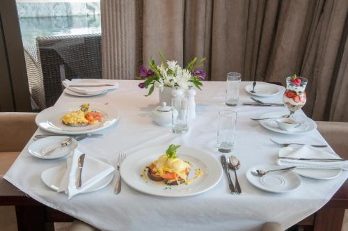 een witte tafel met borden voedsel erop bij The Mount Knysna in Knysna