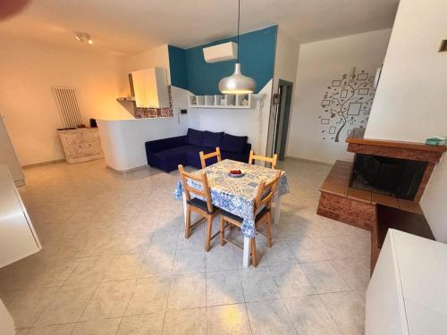 a living room with a table and a blue couch at casa villa degli ulivi in Colonnella