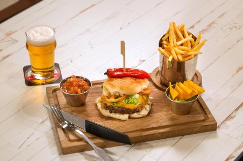 a sandwich and french fries and a glass of beer at RockyPop Chamonix - Les Houches in Les Houches