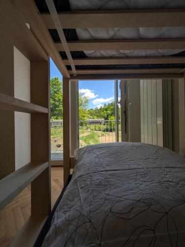 a bedroom with a bed and a large window at Apartmány v Propadání in Jedovnice