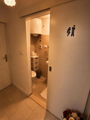 a bathroom with a toilet and a sink at AMD Infinity Suites in Split
