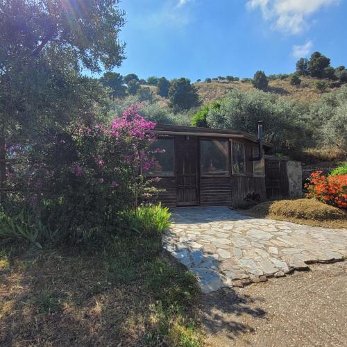 a house with a stone walkway in front of it at Cortijo La Joya in Lanjarón