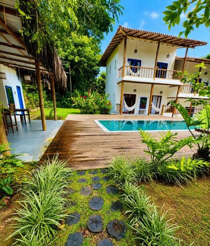 a villa with a swimming pool and a house at Casa Angelina in Trancoso