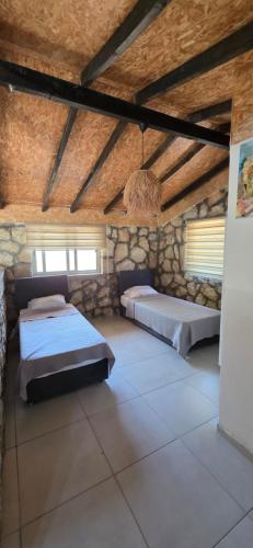 a bedroom with two beds in a stone building at Borak's Stone Village in Rizokarpaso