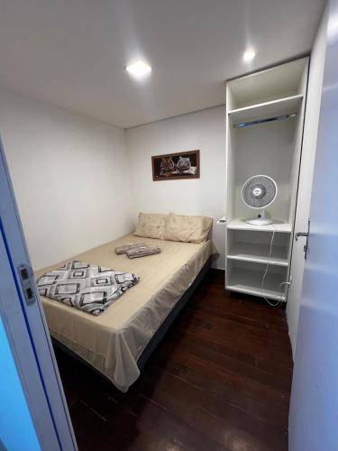 a small bedroom with a bed and a sink at Sunset Hostel in Brasília