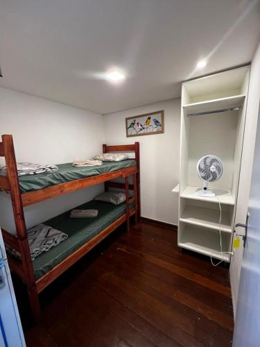 a room with a bunk bed and a closet at Sunset Hostel in Brasília