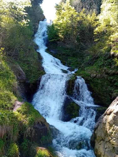 a waterfall on the side of a river at Casa Bisalta relax in San Bartolomeo