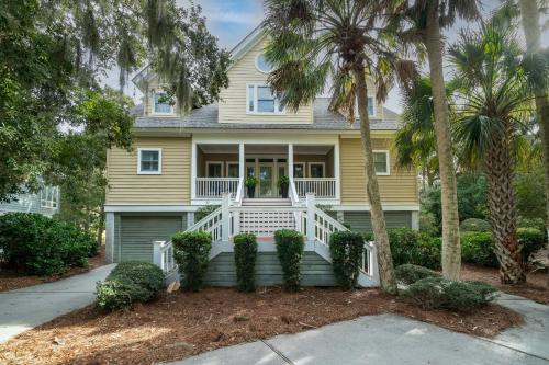 a house with palm trees in front of it at 1005 Crooked Oak Lane in Seabrook Island