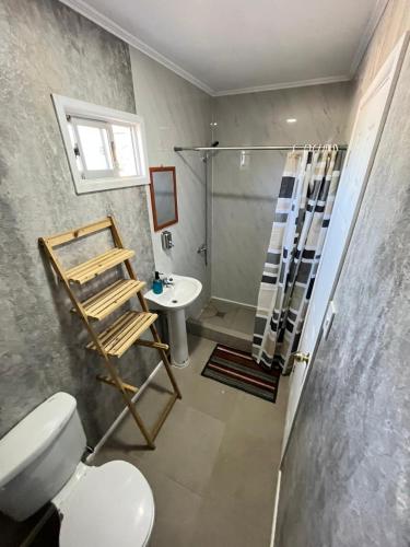 a bathroom with a shower and a toilet and a sink at Hostal JV CASA AMPLIA in Nogales