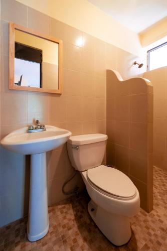 a bathroom with a toilet and a sink at Hotel Rivera Del Mar in Puerto Escondido