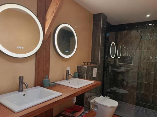 a bathroom with two sinks and a shower at Château des Boulais Suite in Saint-Martin-le-Bouillant