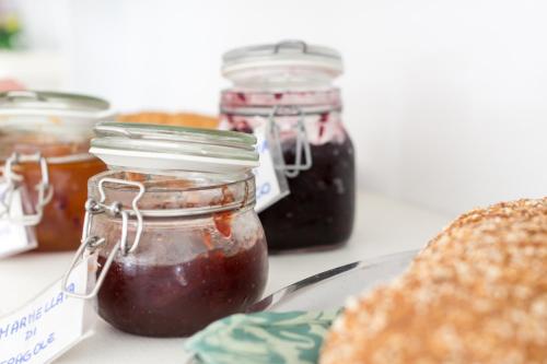 a table with jars of jam and a plate of bread at Hotel Albatros in Rimini