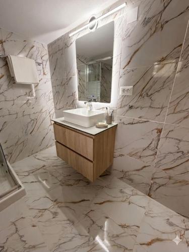 a bathroom with a sink and a mirror at ST-Home in Loutsa