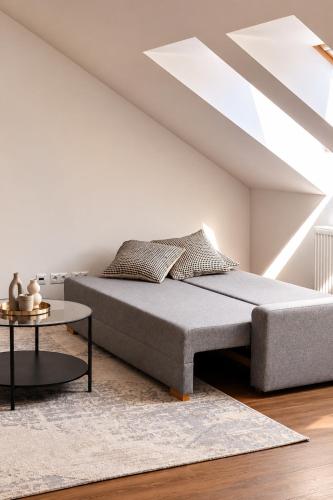 a bedroom with a bed and a table at ATRIO Apartments 3 in Trenčín