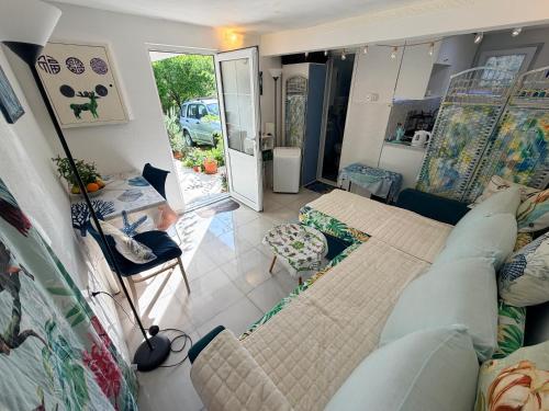 a living room with a couch and a table at Laniakea small apartment in the house in Risan in Risan