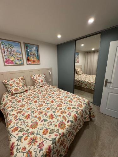 a bedroom with a large bed and a mirror at French Riviera Chic Cocoon - pool, beach, parking in Antibes