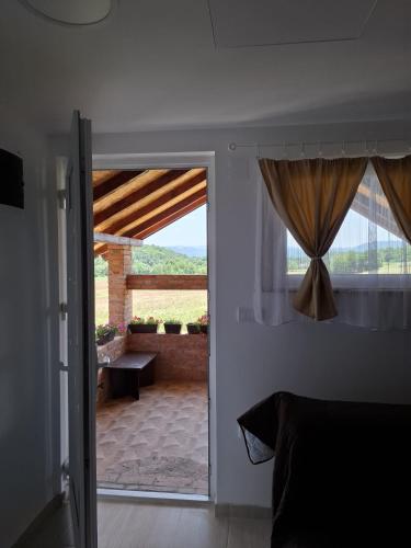 a room with a door open to a patio at Vikendica Garaski kutak sprat in Arandelovac