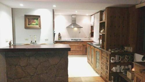 a large kitchen with wooden cabinets and a counter top at Un Espacio de Buscadores in Ingeniero Maschwitz