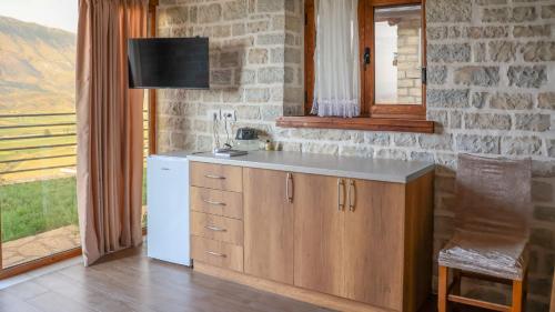 a kitchen with a white refrigerator and a counter at Ballkoni i Goricës in Goricë