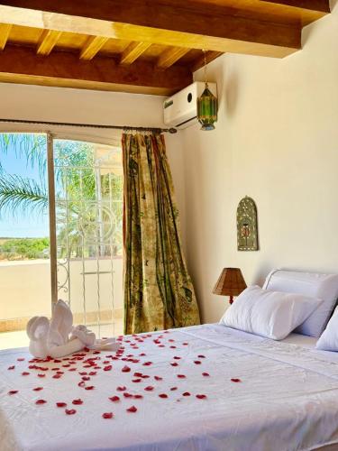 a bedroom with a bed with roses on it at Ferme Oasis de Fes in Fez