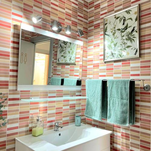 a bathroom with a sink and a mirror and towels at Casa D' alao in Santiago de la Ribera