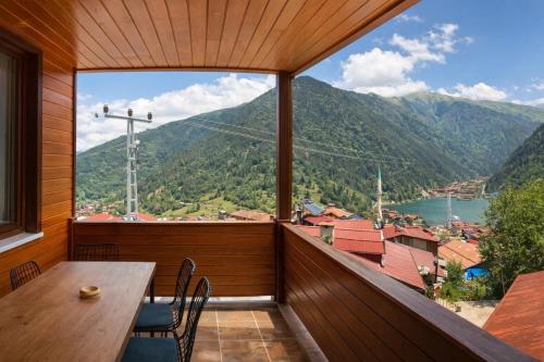 a balcony with a table and chairs and a view at İmera Suite Otel in Uzungöl