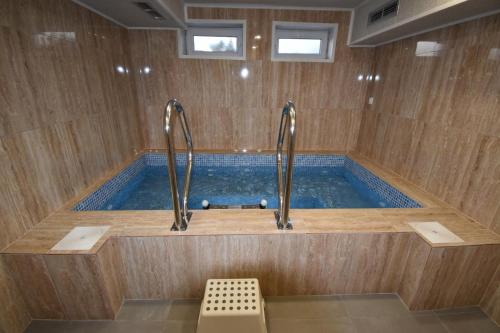 a bath tub with a pool of water at Simada Center Guesthouse in Varshets