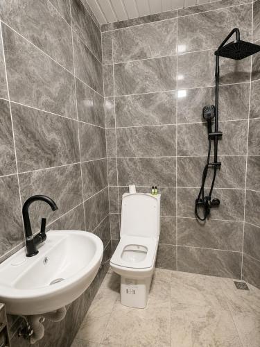 a bathroom with a toilet and a sink at Deal Otel in Uzungöl