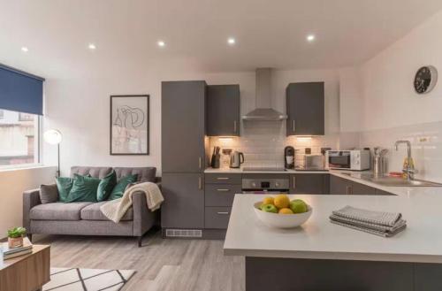 a kitchen and living room with a couch and a table at Comfortable 1 Bed Apartment Town Centre in Preston
