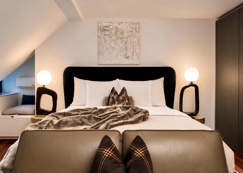 a bedroom with a bed with a pair of shoes on it at The Crown Penthouse Bahnhofstrasse in Zurich