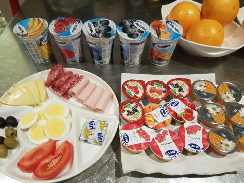 a table topped with plates of food and drinks at Hotel Bahnhof in Uzwil