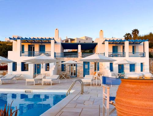 a villa with a swimming pool and a resort at White Blue Houses & Apartments Paros in Parikia