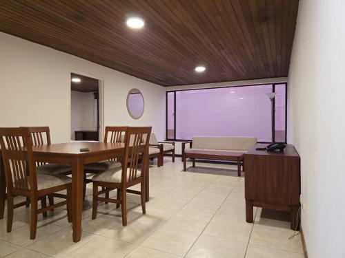 a dining room with a table and chairs at Apartamentos Percales in Bogotá