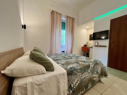 a bedroom with a bed with green lights on it at DMC - Alloggio Turistico in Anzio