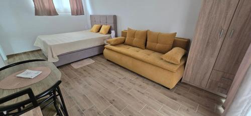 a living room with a couch and a bed at Camp Kalinovac in Zatonje