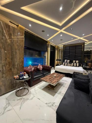 a living room with a bed and a couch and a table at Hilton Suites Lahore in Lahore