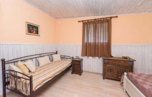 
a room with a bed, a chair, and a window at Villa Argo, Feakia in Agios Gordios
