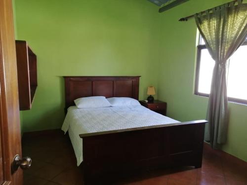 a bedroom with a bed and a window at Hotel & Resort Casa Bella in El Hawaii