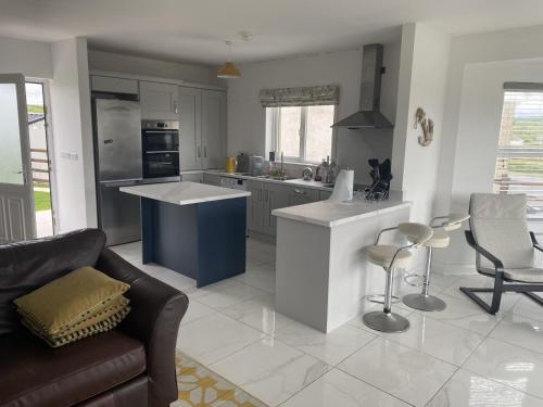 a kitchen with a couch and a table in a room at Beach House in Donegal