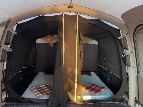 an inside of a tent with the door open at Blue Camping in Borsh, Vlorë in Borsh