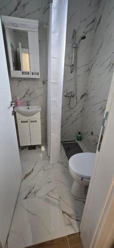 a white bathroom with a sink and a toilet at Camp Kalinovac in Zatonje